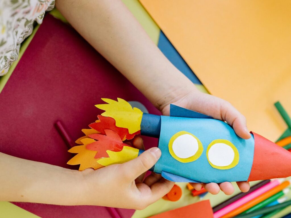 kid playing with toy rocket